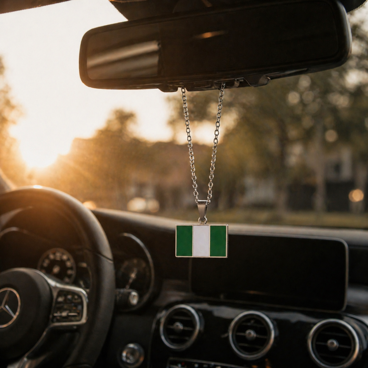 Nigeria Flagge Anhänger in Silber hängt am Rückspiegel eines Mercedes – rechteckiges grün-weißes nigerianisches Schutzamulett fürs Auto